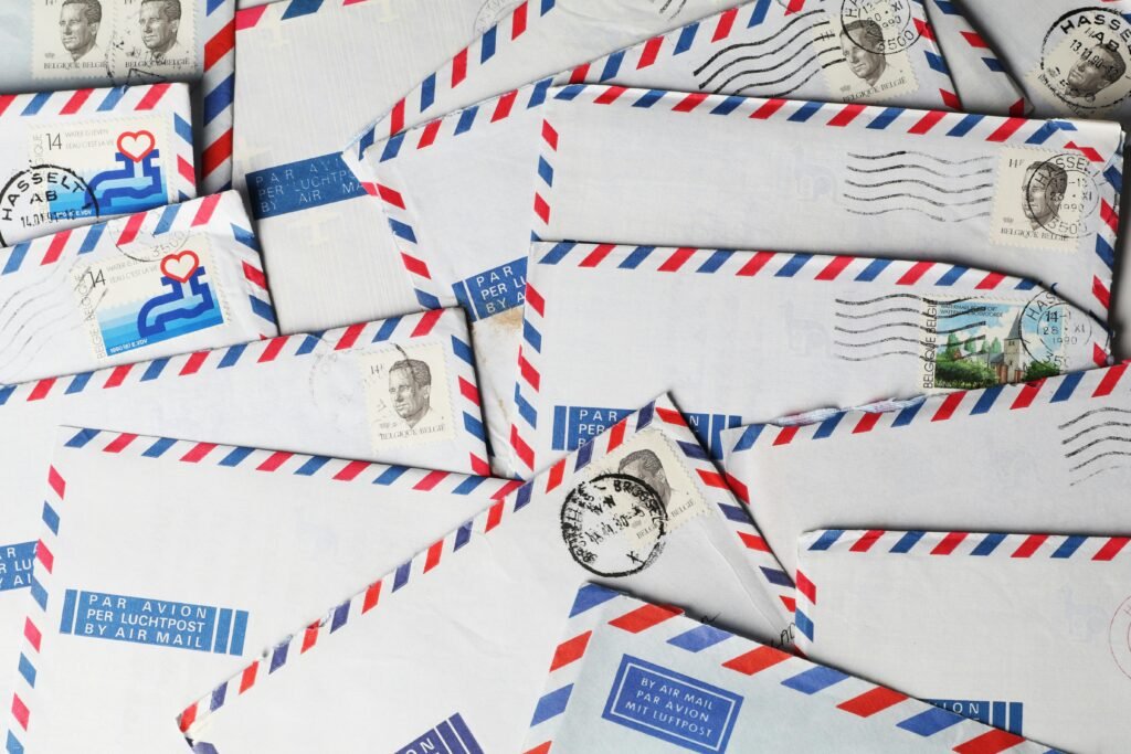 A close-up of vintage airmail envelopes with stamps and postmarks, showcasing nostalgic design.